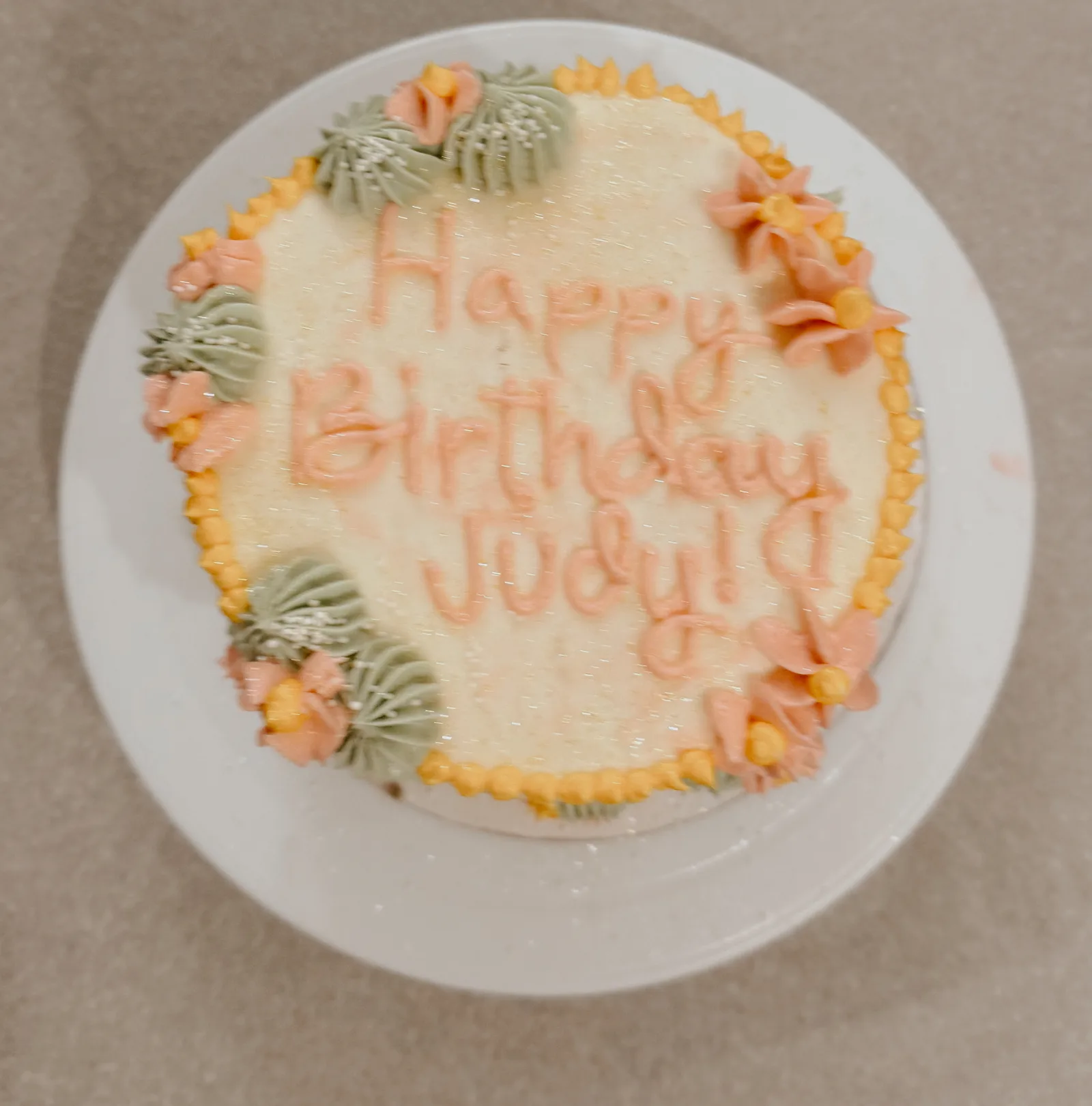 Buttercream birthday cake with floral piping